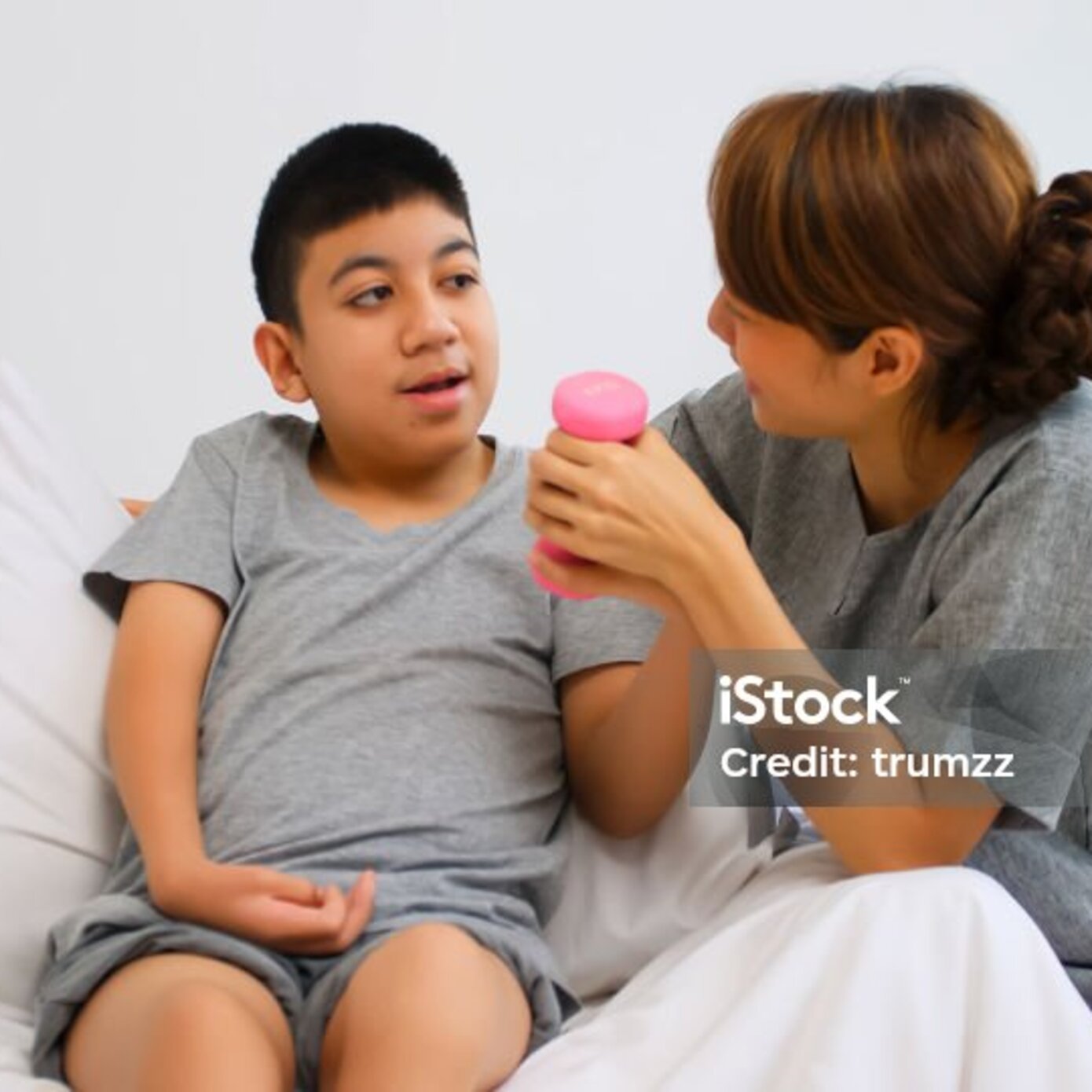 more detail, image of child with pink dumbbell